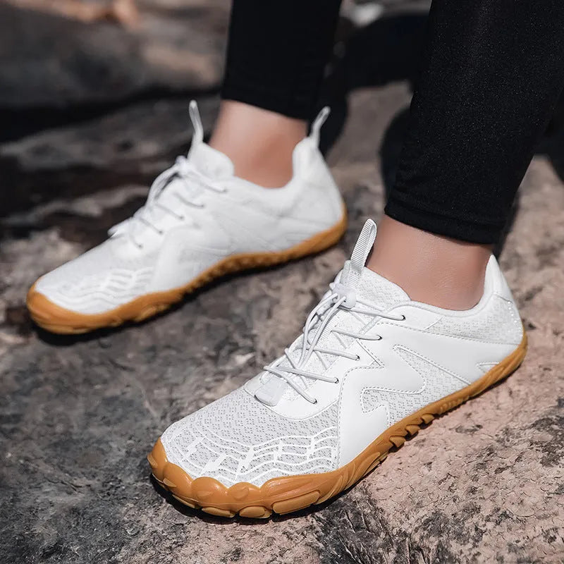Unisex flyknit-lined climbing shoes with rubber sole in multiple colour options on a climbing hold.