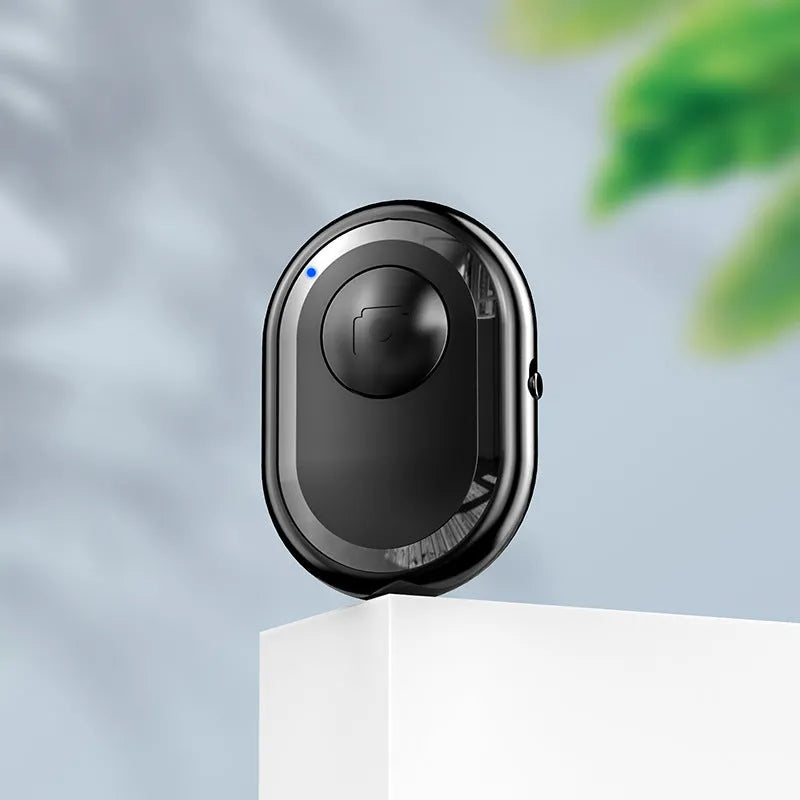Small black wireless Bluetooth remote control for smartphone photography