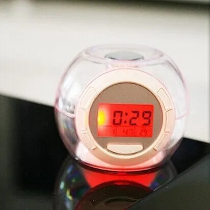 White colourful natural sound alarm clock with large LCD display showing time and temperature, featuring 6 nature sounds and 7 colour cycle night light