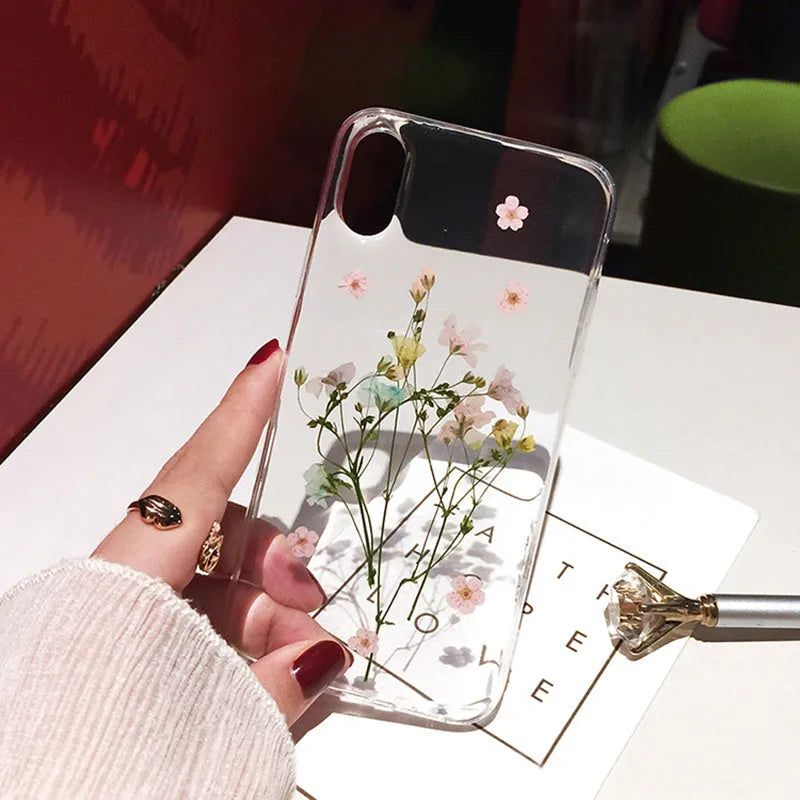 Qianliyao handmade clear TPU iPhone case with pink dried flowers encased in epoxy resin on the back.