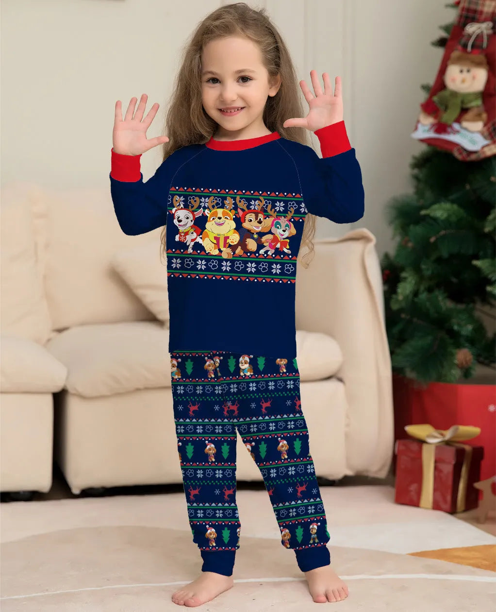 Family wearing matching red deer plaid Christmas pyjamas with adults, children, baby, and dog