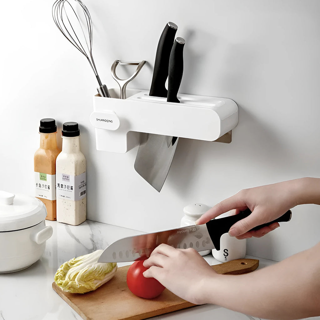 White plastic freestanding kitchen knife rack on a countertop.