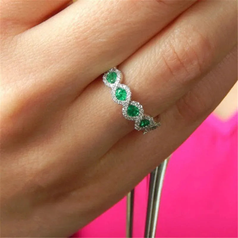 Micro-set ruby and green zircon ring in alloy, shown in green and gules with US size 5 to 12 chart