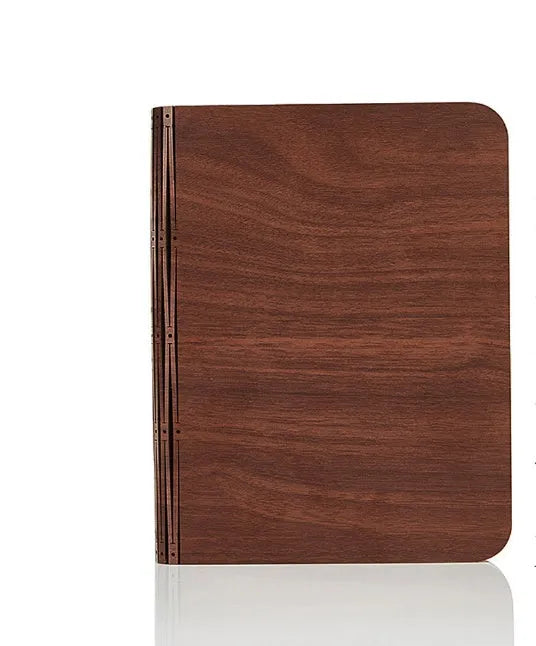 Solid wood book light in three sizes on a desk, showing white and warm white light options.