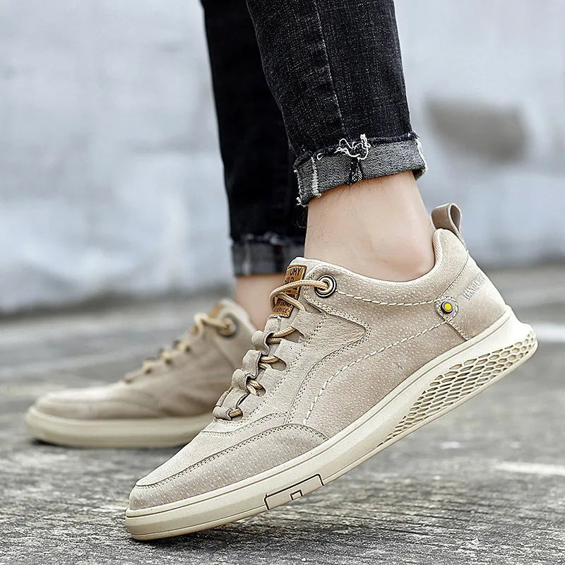 Men's brown leather sports shoes with suede finish and anti-skid plastic sole on concrete background
