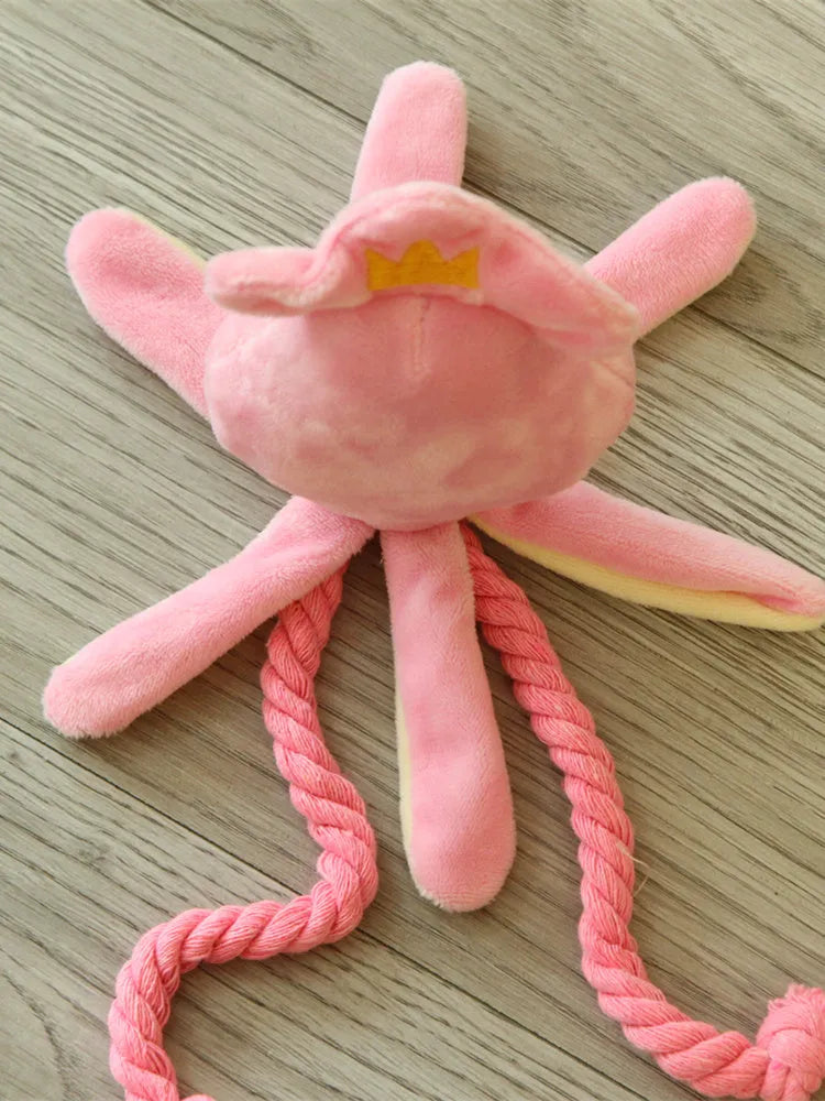 Pink octopus pet plush toy rope toy for dogs with soft fabric head and rope body on white background
