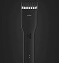 Black cordless electric hair clippers with ceramic blade and adjustable comb on a white background