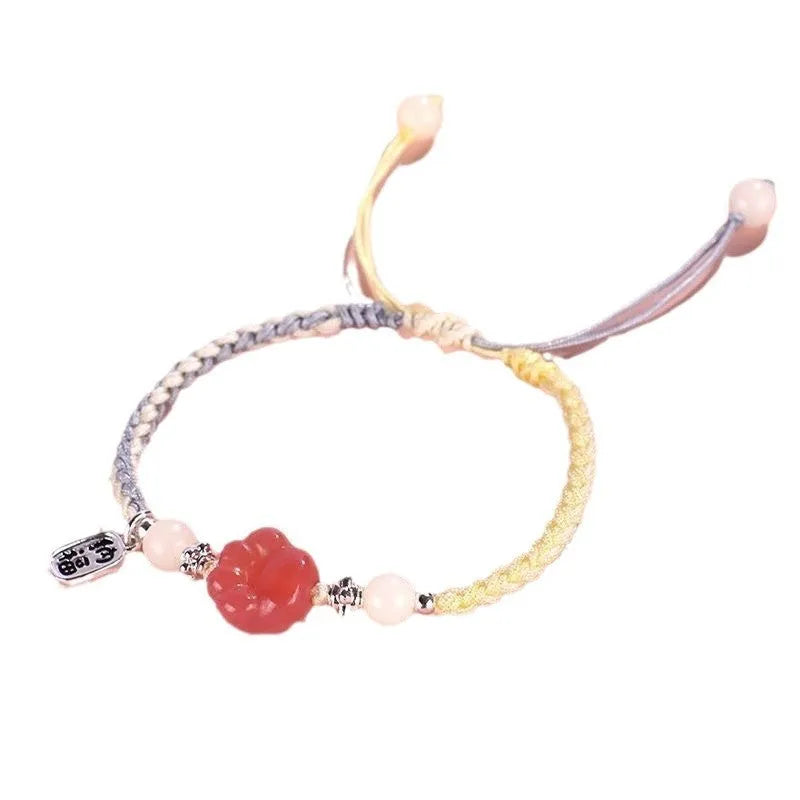 Handmade red cat's paw charm bracelet with pink woven band for couples.