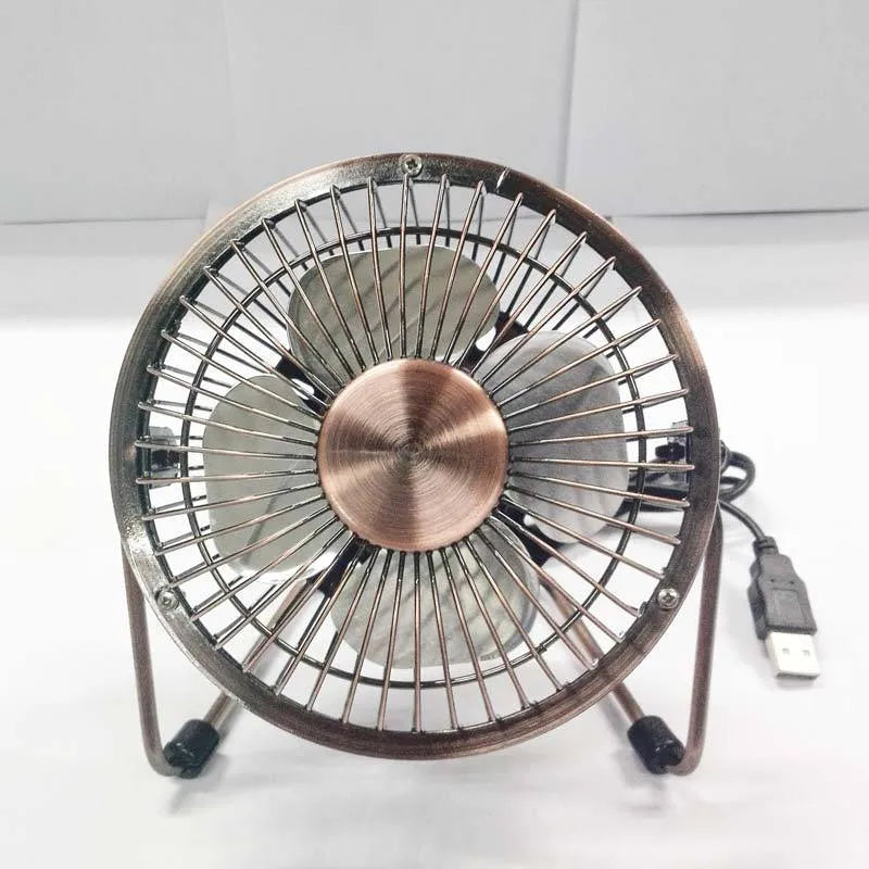 4-inch bronze aluminium USB mini fan with rocker switch on a desk