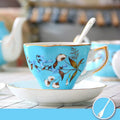 European style porcelain coffee cup set with saucer and pastoral ceramic plates on a dining table