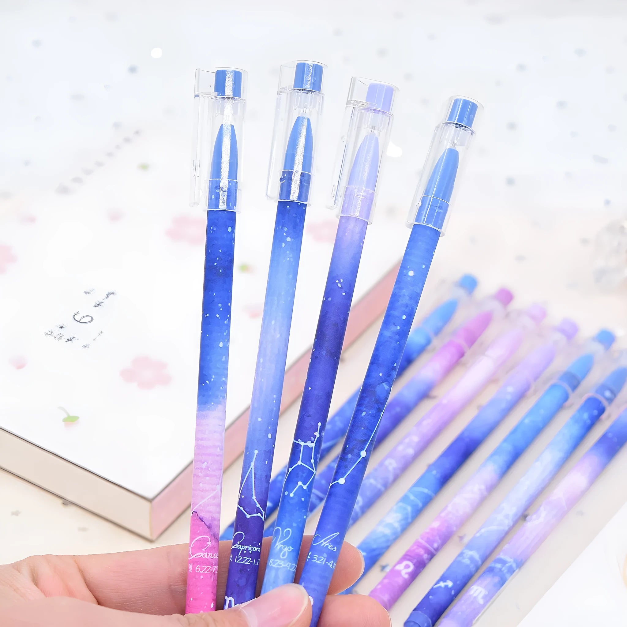 Box containing twelve constellation themed quick-drying gel pens for office use