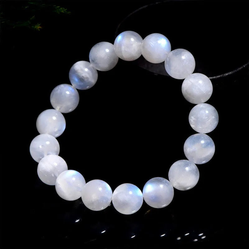 Natural blue moonstone round beads strung on a white cord bracelet.