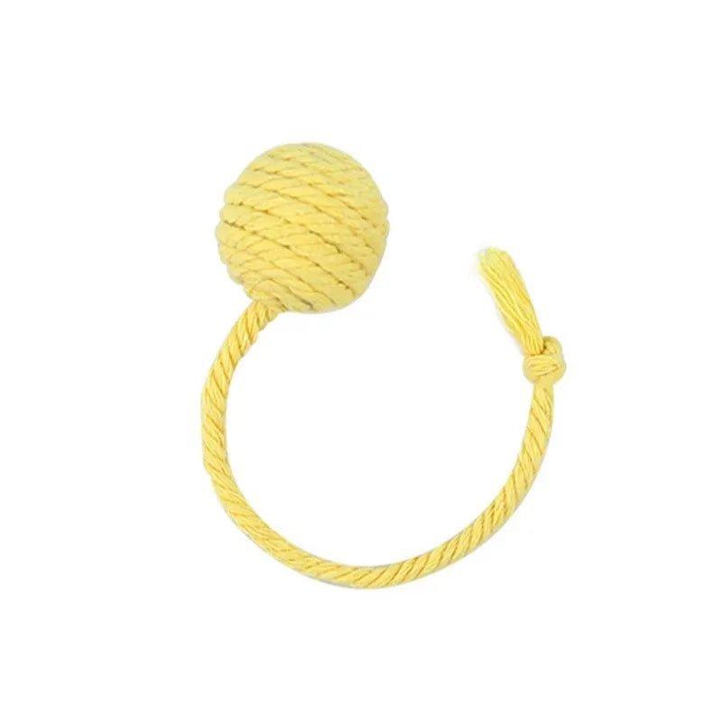 Cat toy ball with rope handle in green, pink, purple or yellow colours with internal bell