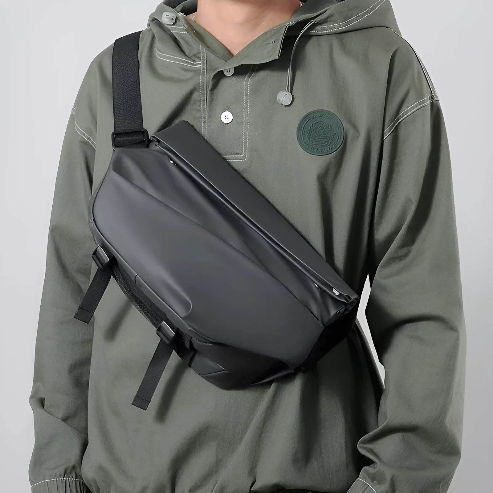 A medium-sized grey crossbody bag for men made from PU leather with a single shoulder strap.