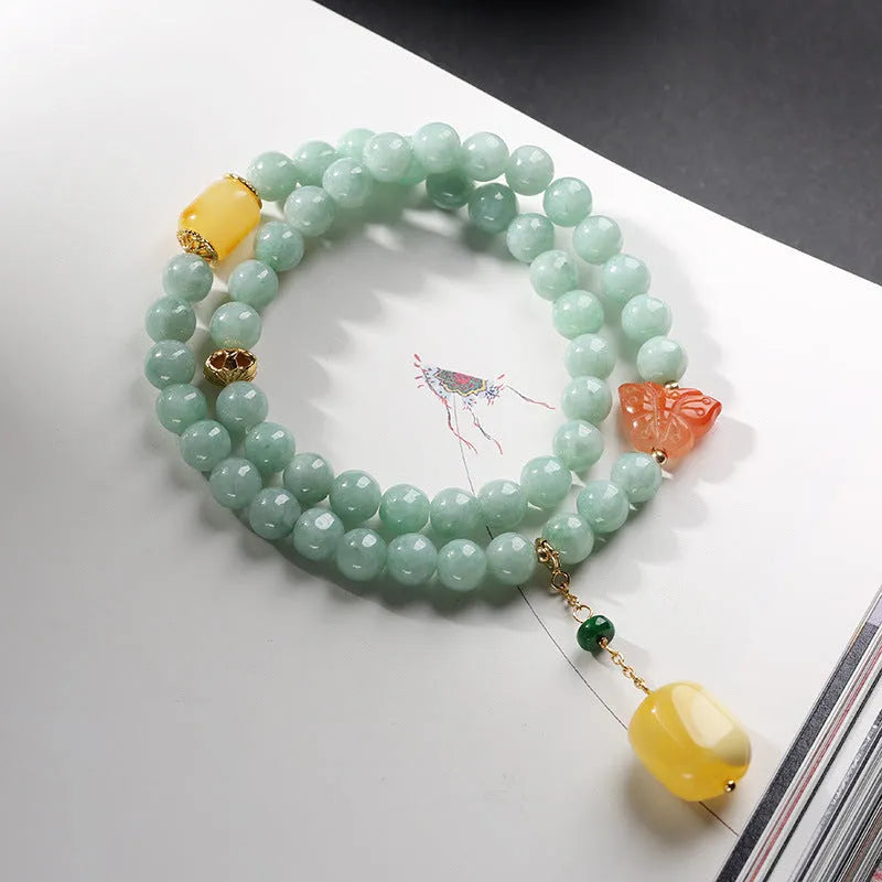 Double-layer retro bracelet with emerald jade round beads and hanging beeswax barrel beads.