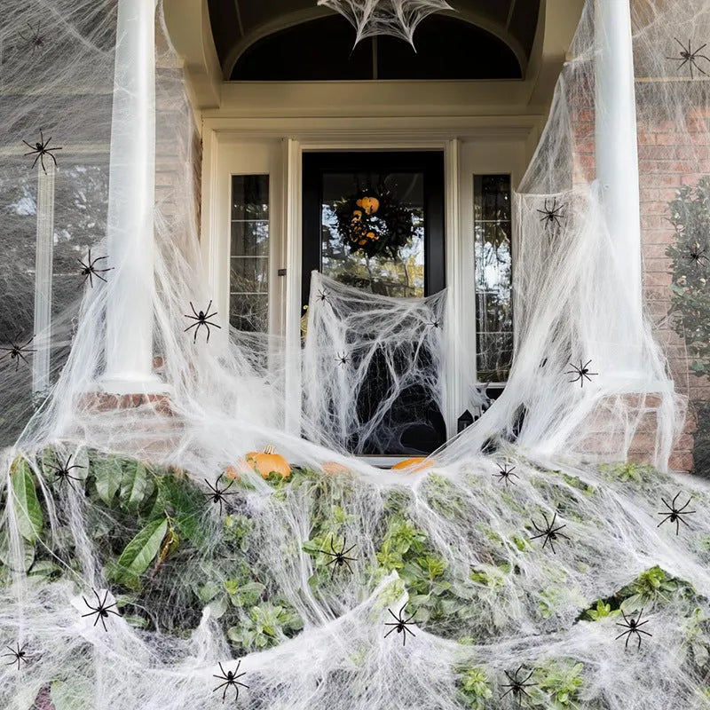Cotton spider web Halloween decoration set with artificial spiders on dark background
