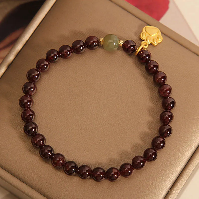 Cat's paw garnet crystal bracelet for women showing clear beads with feline charm
