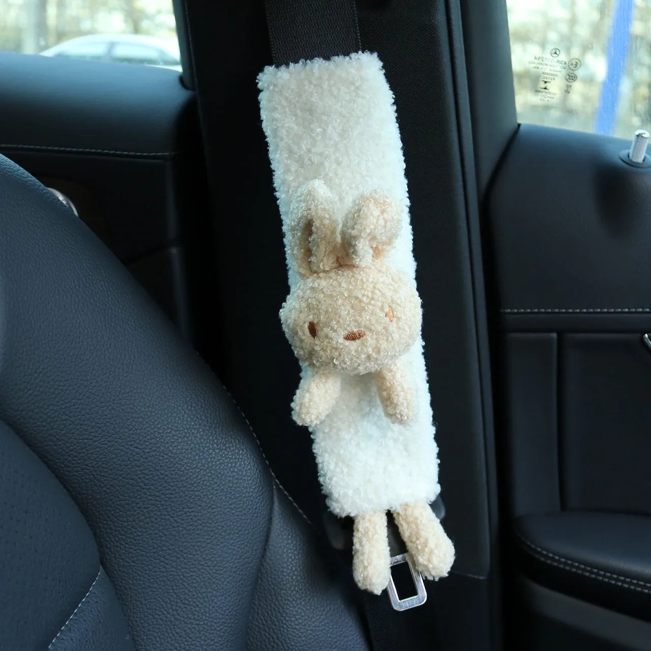 Cartoon plush lamb's wool shoulder protector for car seat belt in rabbit and bear designs.
