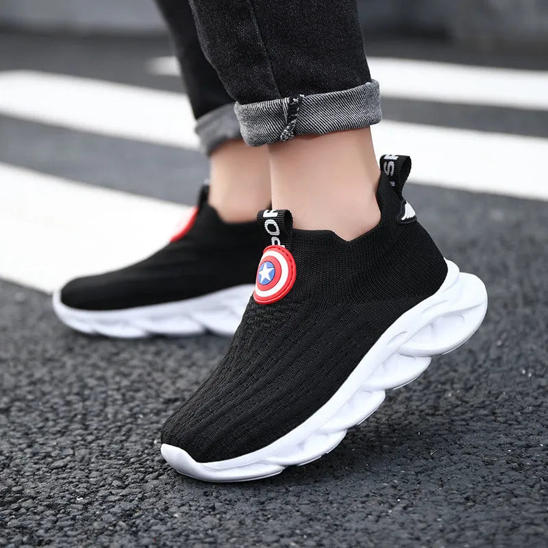 Children's black and white knitted overshoes with sleeve opening for runway or dance performances.