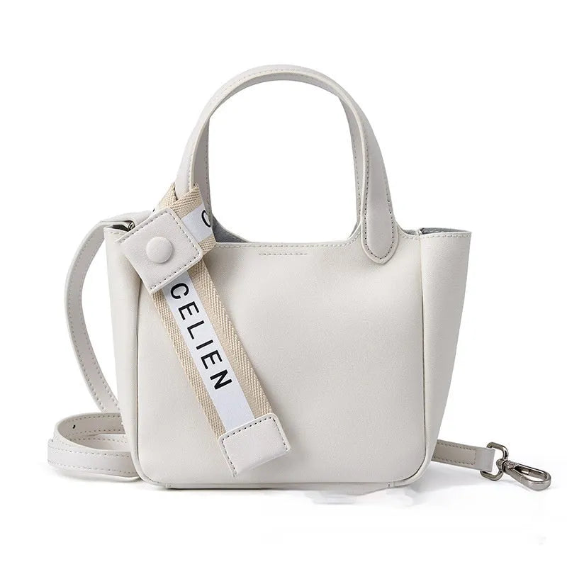 Brown cattlehide leather cross body bucket bag with square vertical design and slit pocket