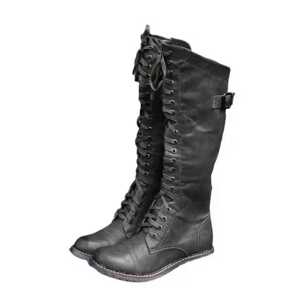 Black chunky heel high-leg casual boot with round toe and low rubber sole on a plain background.