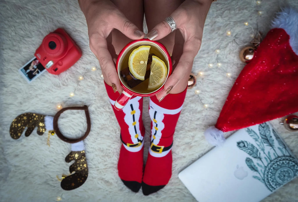 Pair of red Christmas Santa socks with cotton construction, crew length, and festive design