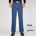Men's high-waist loose fit blue denim jeans with zipper fly on size chart background