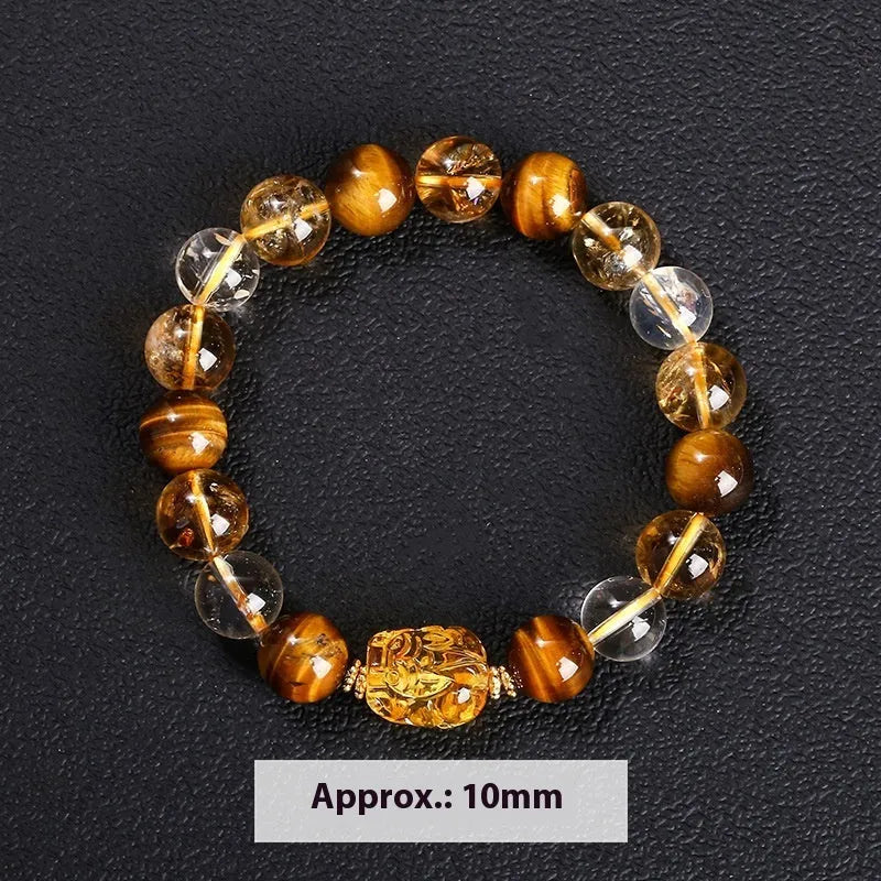 Natural yellow tiger's eye and citrine bracelet with 10mm round beads and a silver pi xiu charm on a wrist.