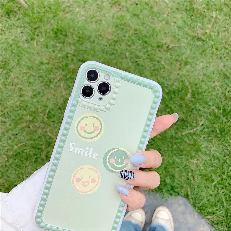 Geometric smiley face TPU iPhone case with polka dot frame on iPhone