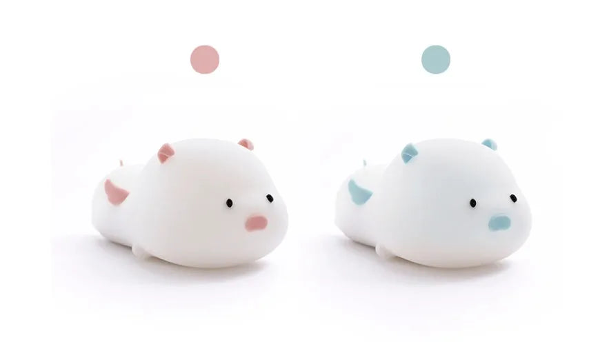 Blue silicone pig-shaped night light with USB charging port