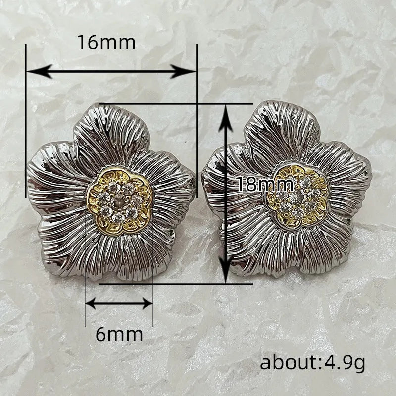 Copper stud earrings with textured gardenia flower design and two-tone electroplated finish.