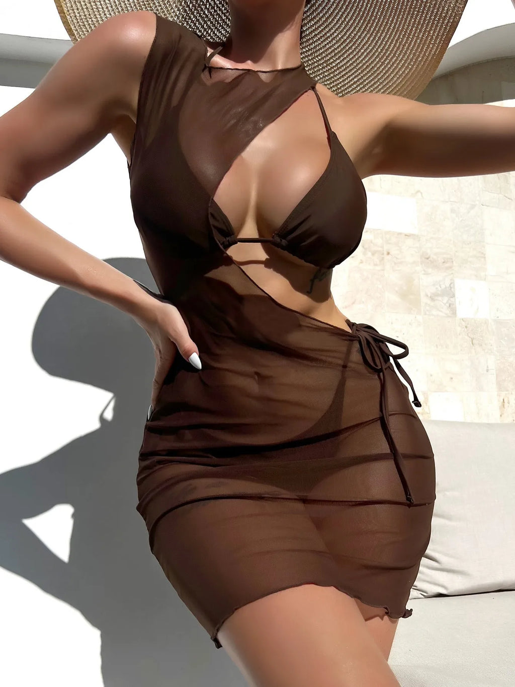 Brown women's three-piece bikini set showing bra, shorts, and blouse laid flat.