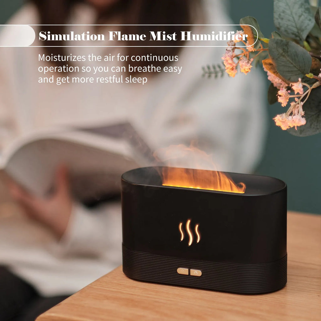 Square black ultrasonic aroma diffuser with flame light effect and water tank on a wooden table.