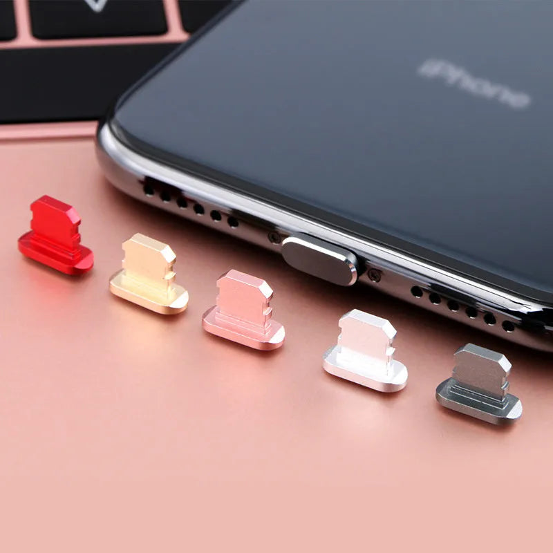 Aluminium alloy dust plug for iPhone charging port in various colours including gold and black.