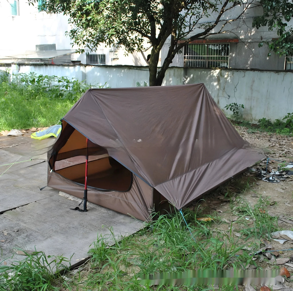 Brown A-line pole-free tent erected with hiking canes showing 2-3 person capacity and waterproof fabric construction