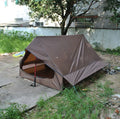 Brown A-line pole-free tent erected with hiking canes showing 2-3 person capacity and waterproof fabric construction