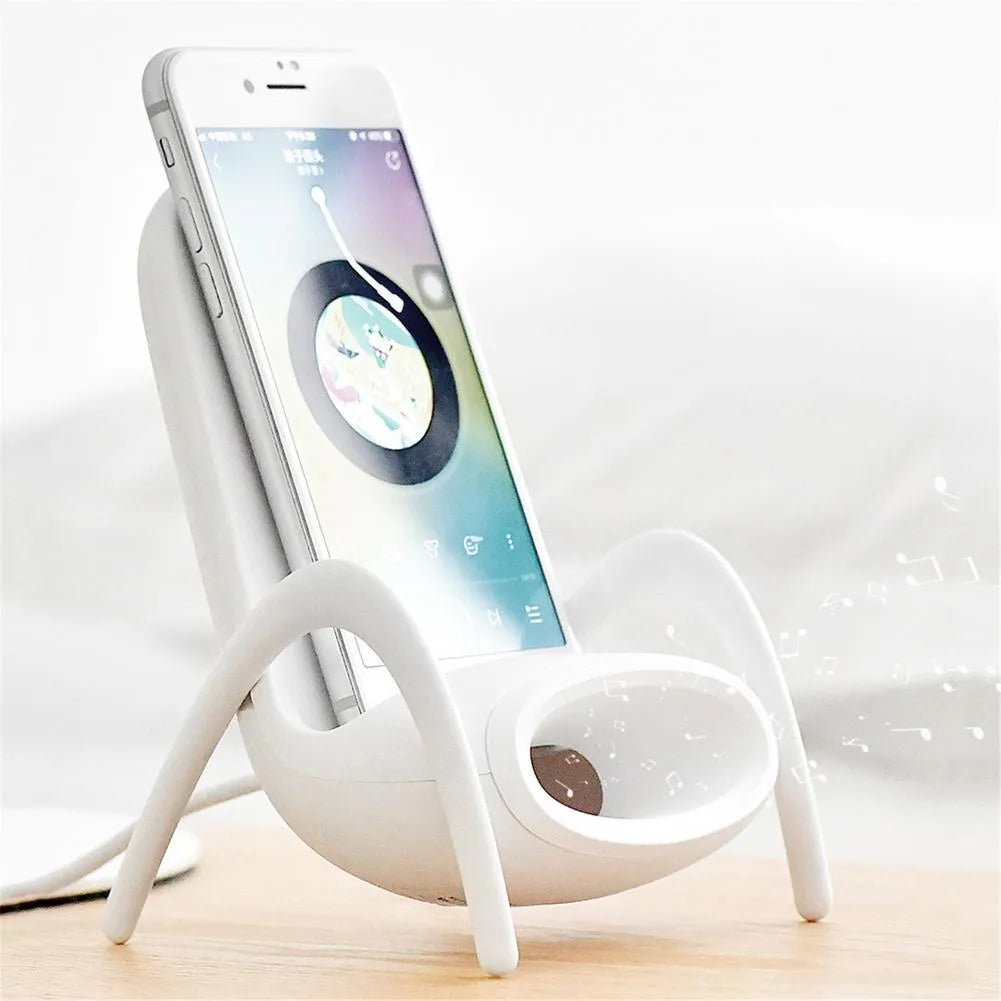White mini chair shaped wireless charging stand holding smartphone with cable connection