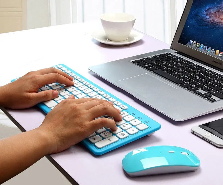 Wireless keyboard and mouse set in choice of colours with USB receiver on desk