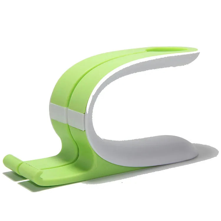 Grey and green Apple Watch and iPhone dual charging stand on a desktop.