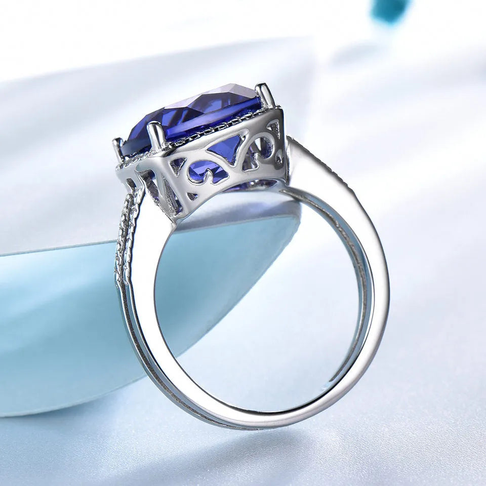 Blue tanzanite stone set in sterling silver women's ring with alloy accessory