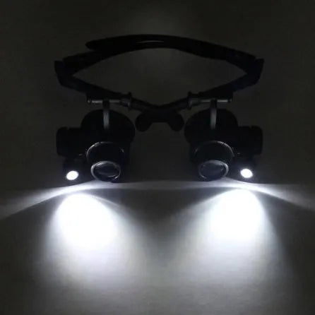 Black double eye magnifier glasses with LED lights and multiple lenses for hands-free watch and electronic repair.