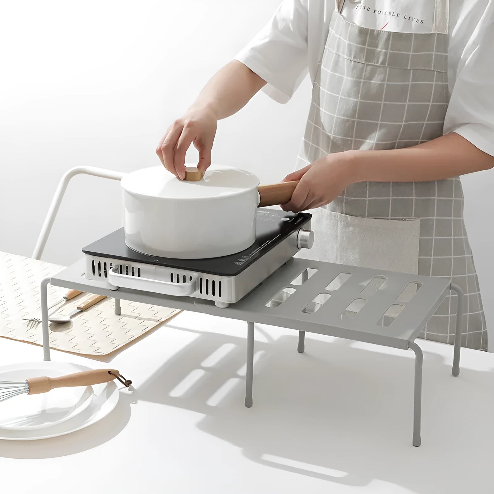 White telescopic plastic kitchen storage rack at adjustable height