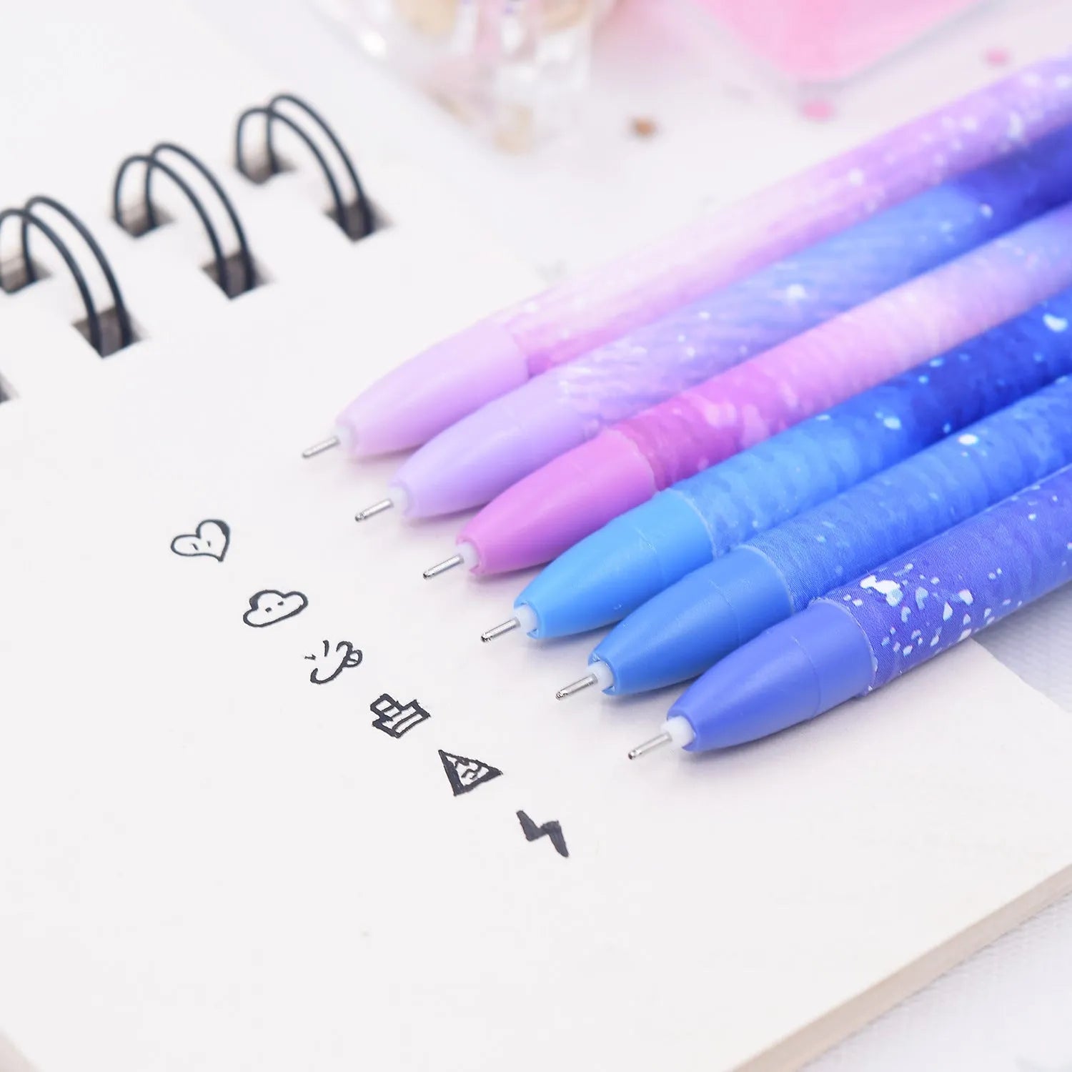 Box containing twelve constellation themed quick-drying gel pens for office use