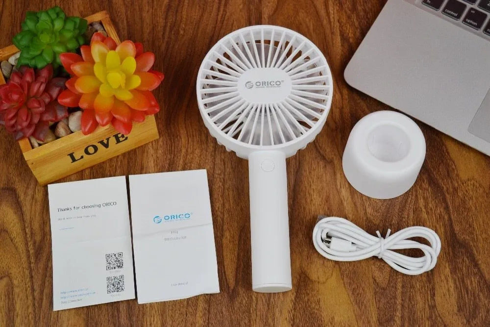 White ORICO FH1 portable USB rechargeable desk fan on a table