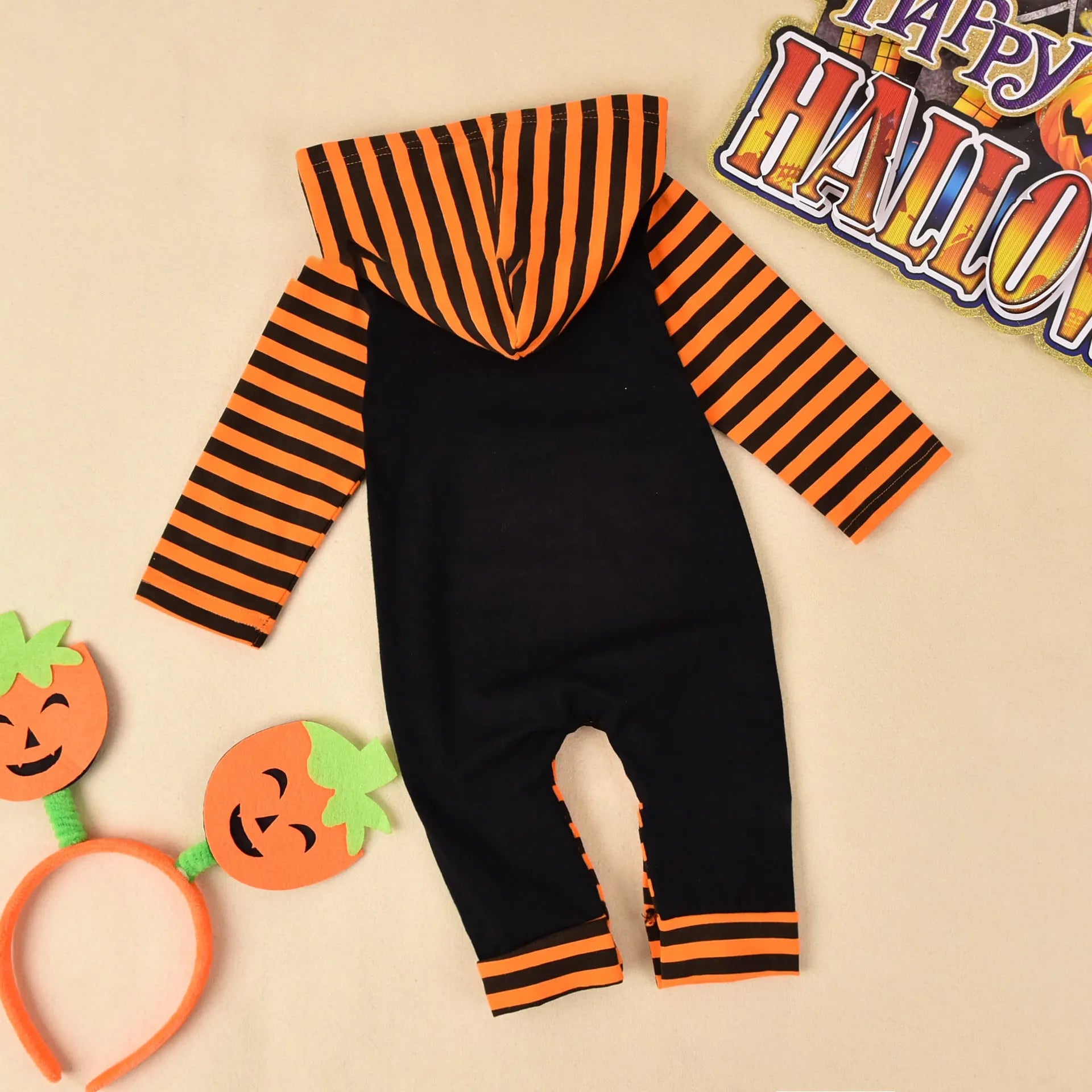 A black or brown cotton Halloween romper for children with long sleeves and a hood.
