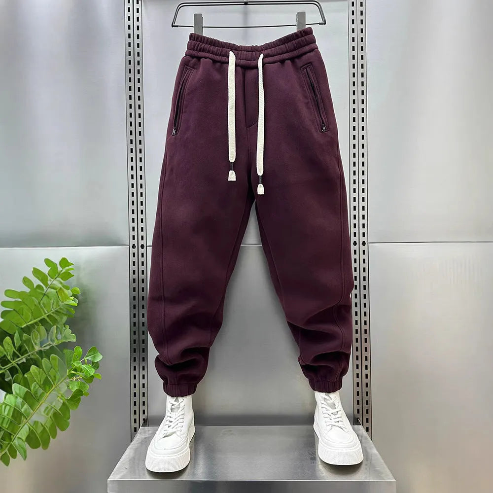 Summer men's solid colour polyester track sweatpants with zippered pockets and ankle ties, black, side view
