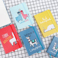 Cartoon alpaca design notepad showing cover, available in A5, A6, and A7 sizes with yellow paper pages.