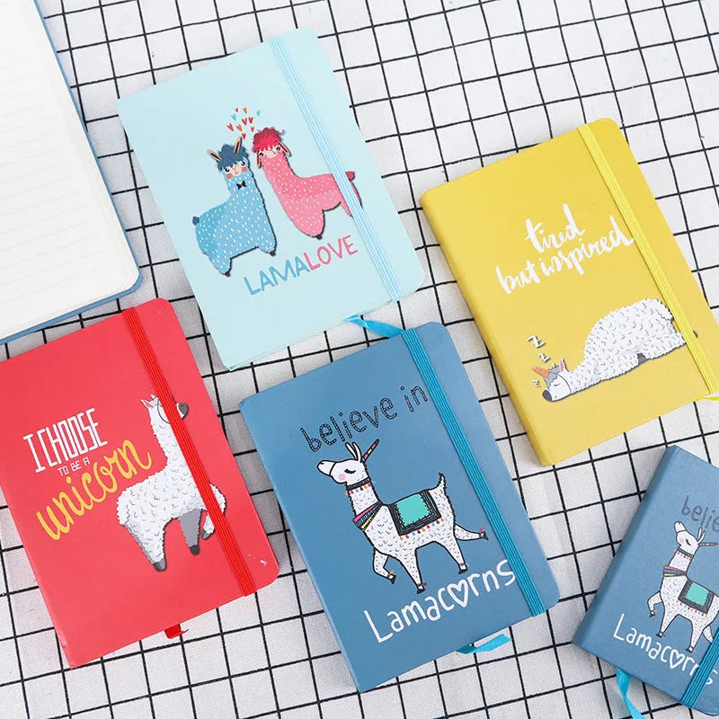 Cartoon alpaca design notepad showing cover, available in A5, A6, and A7 sizes with yellow paper pages.