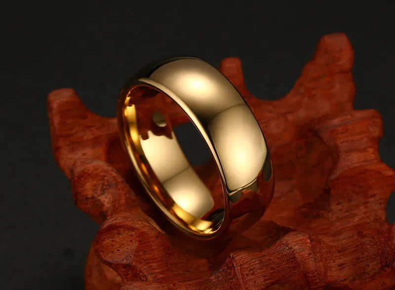 Gold tungsten carbide signet ring on display showing unisex design and metallic finish