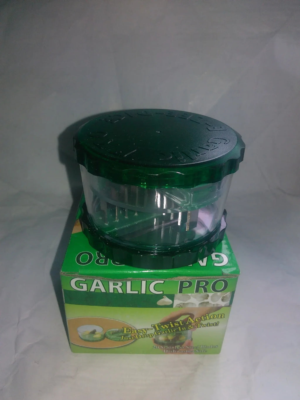 Green transparent silicone garlic peeler tube on a kitchen counter